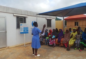 Patients waiting at one of ePHC’s clinic while a nurse gives directives.